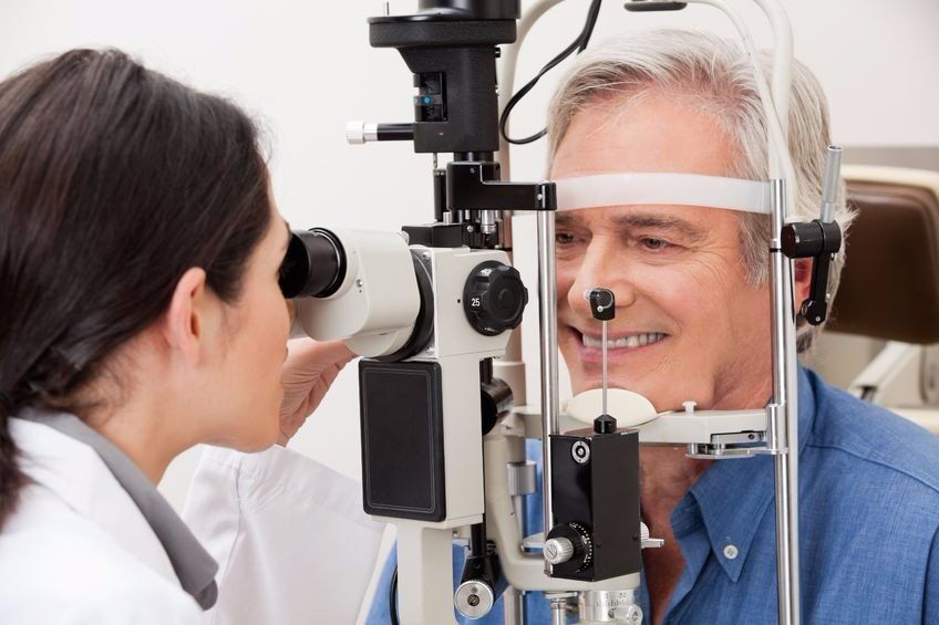 A man is getting his eyes examined by an optometrist