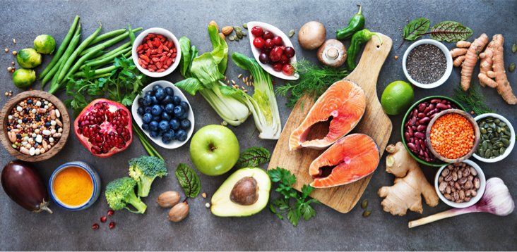 There are many different types of fruits and vegetables on the table.