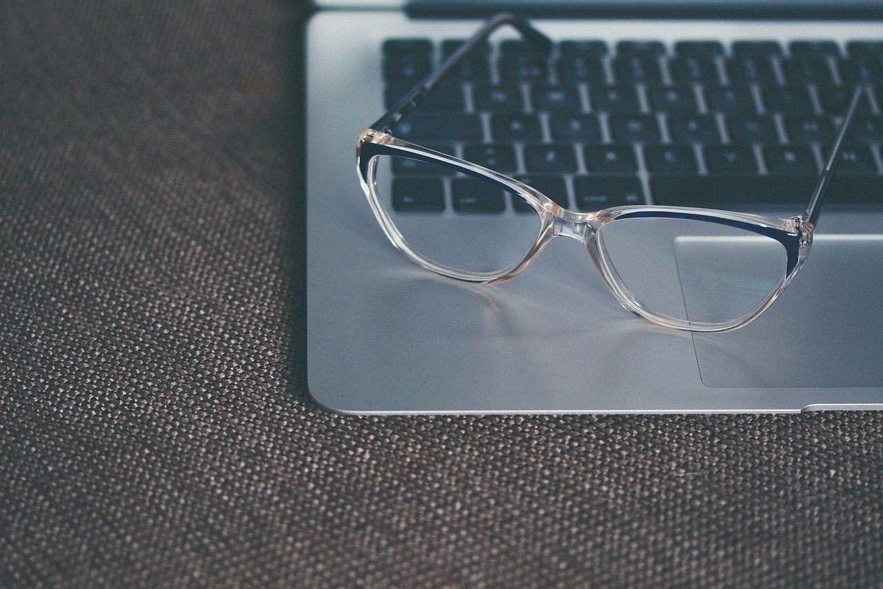 eye glasses sitting on a laptop computer