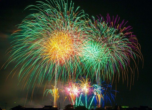 A bunch of colorful fireworks are exploding in the night sky.