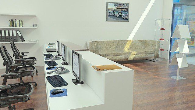 An office with a couch and a row of computers