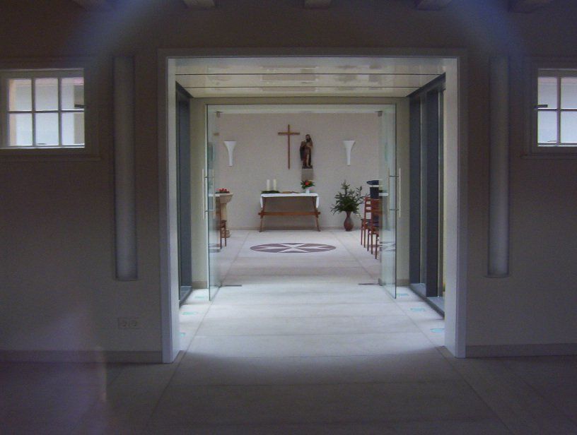 The inside of a church with a cross on the altar