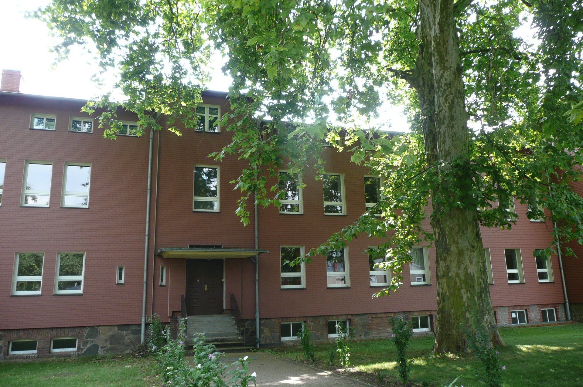 A large brick building with trees in front of it