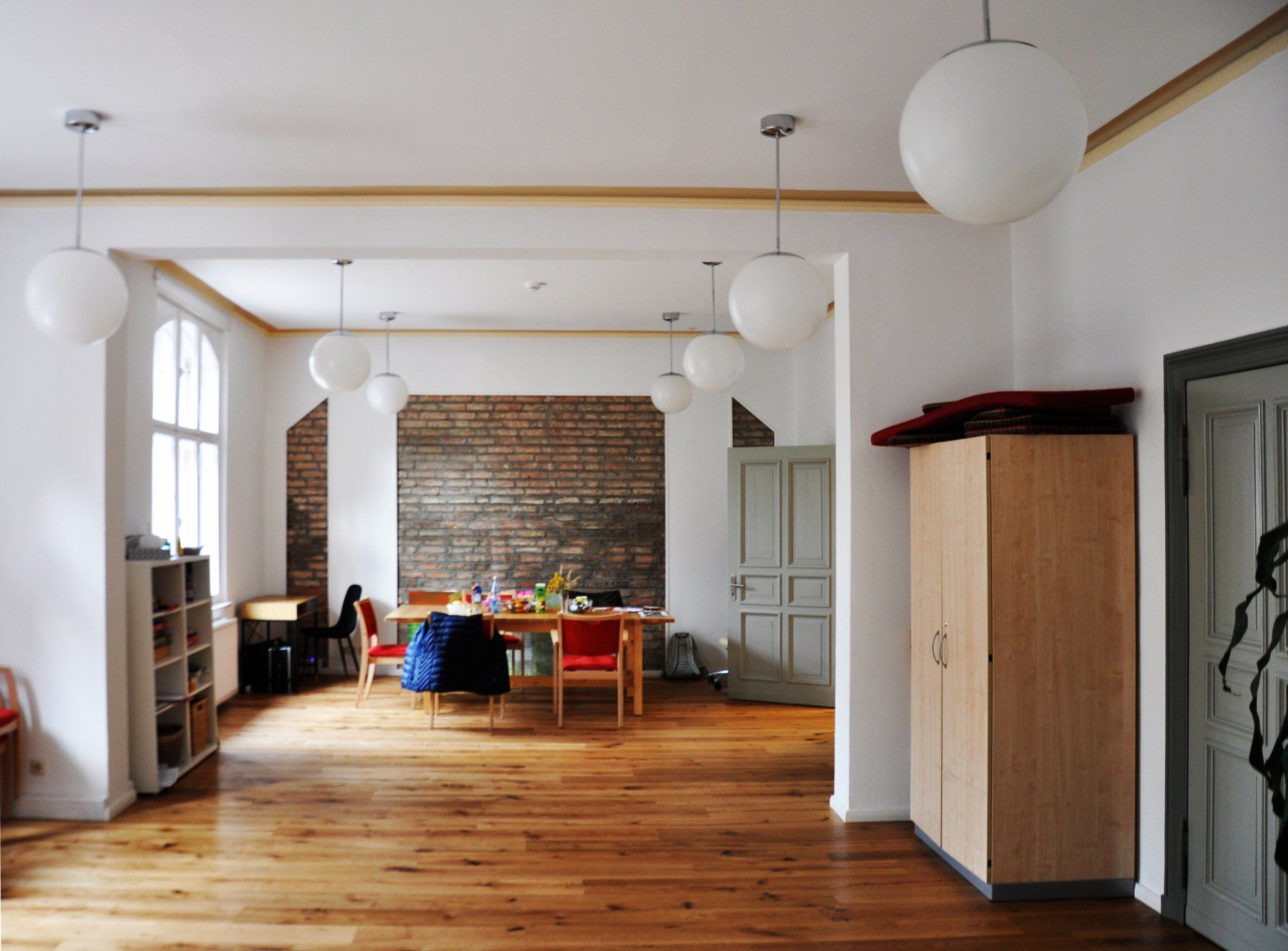 A large room with a table and chairs in it