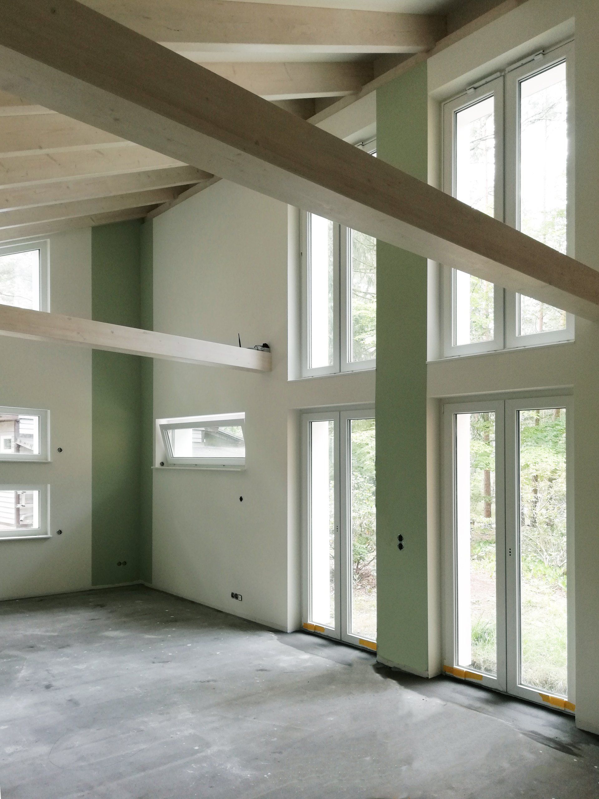 An empty room with a lot of windows and a wooden ceiling