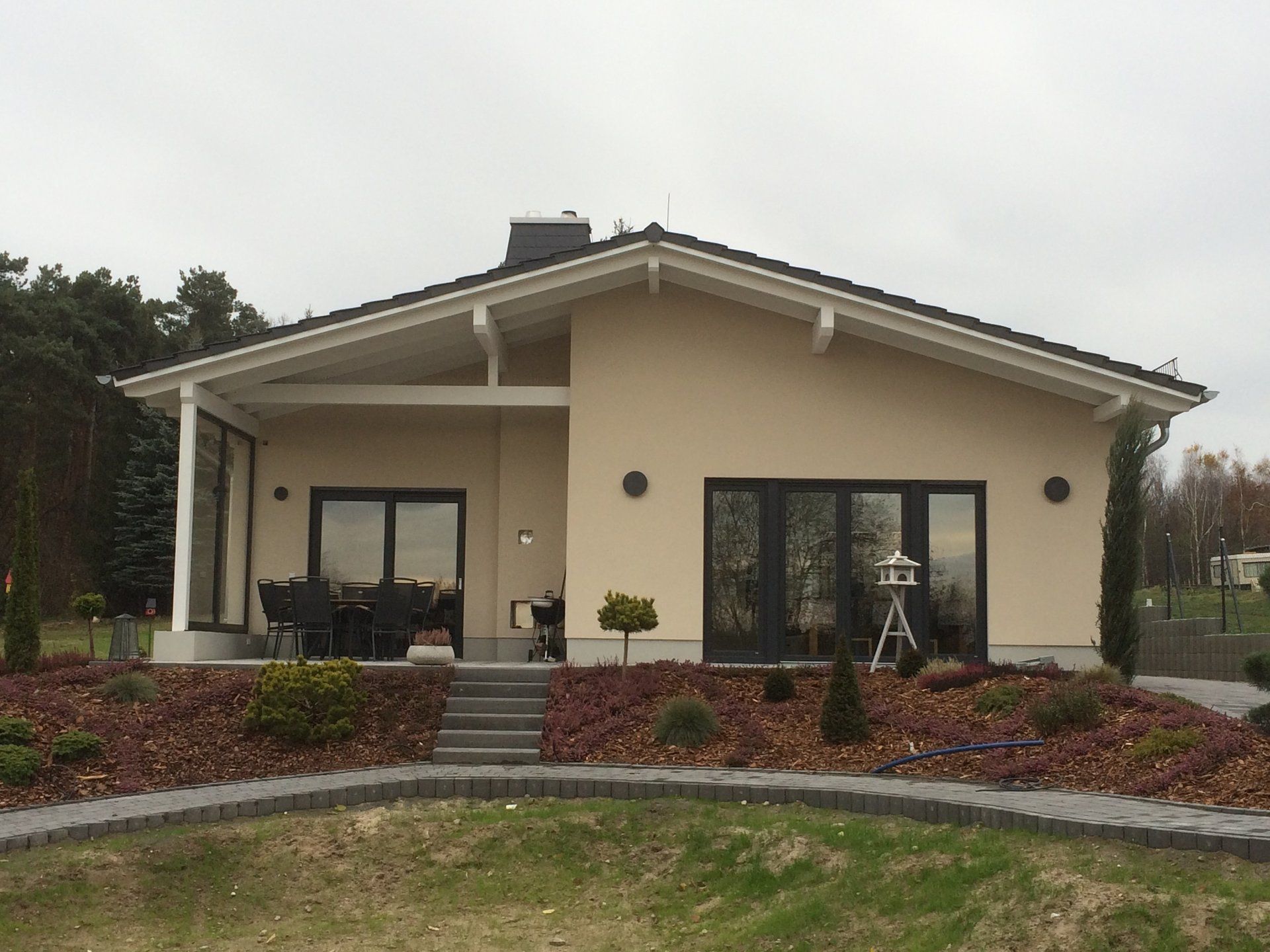 A small house with a lot of windows and a porch