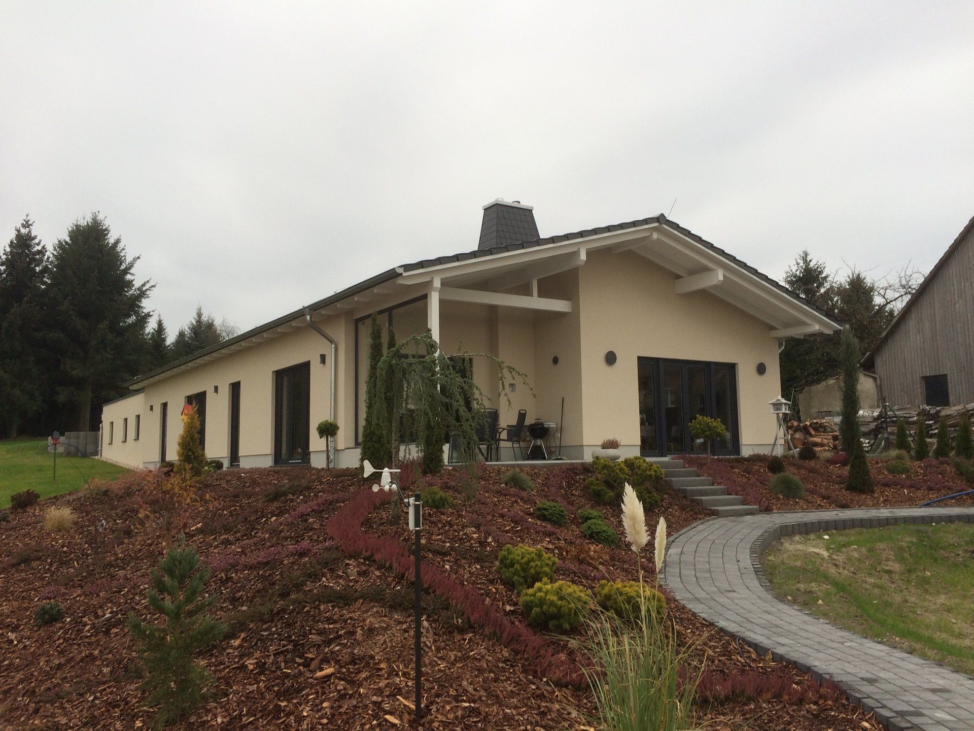 A house with a lot of windows is sitting on top of a hill
