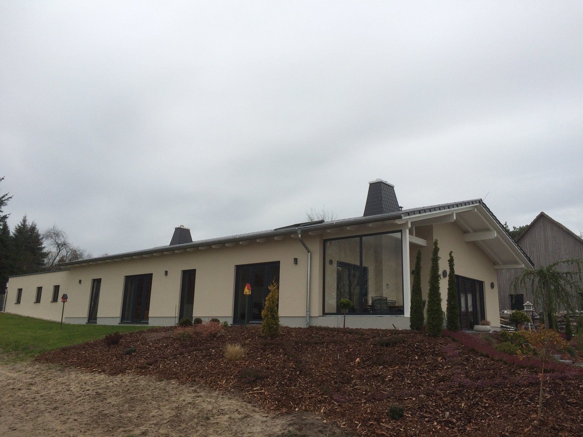 A large white house with a lot of windows is sitting on top of a hill.