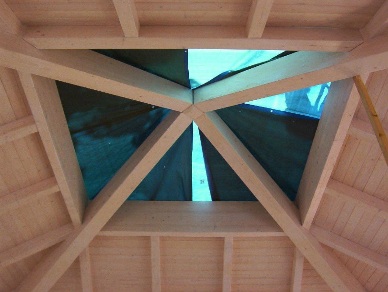 Looking up at a wooden structure with a skylight