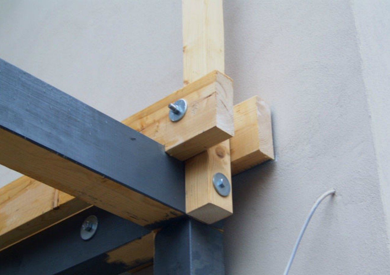 A close up of a wooden structure attached to a wall.