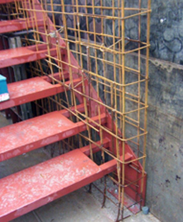 A red staircase with a metal fence around it