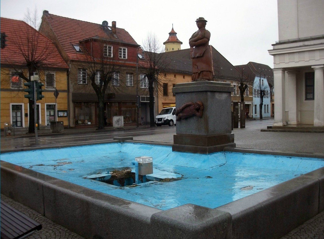 A fountain with a statue in the middle of it
