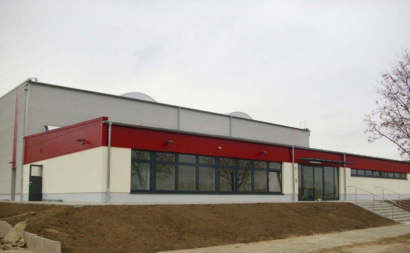 A large white building with a red roof