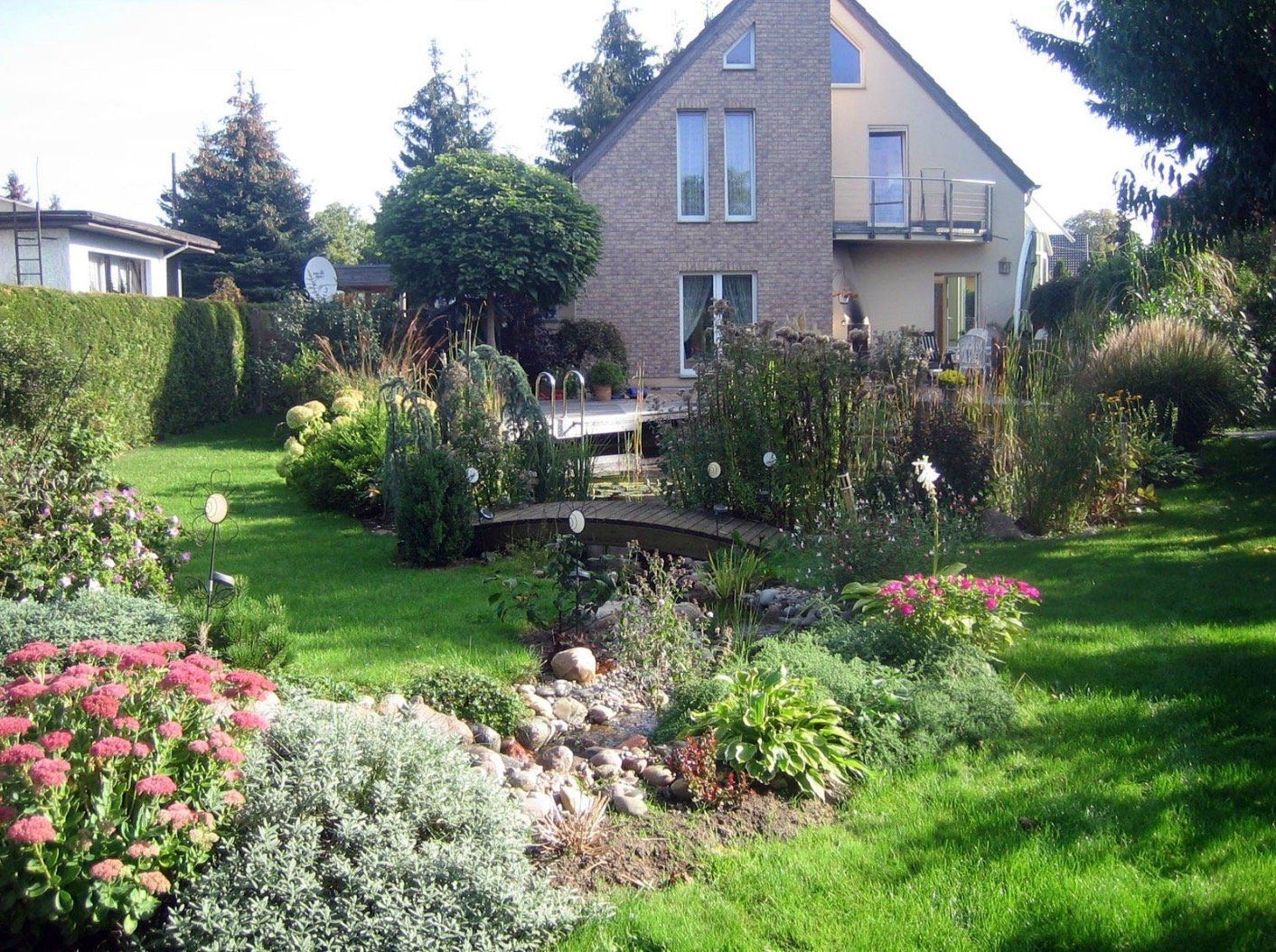A house is surrounded by a lush green garden