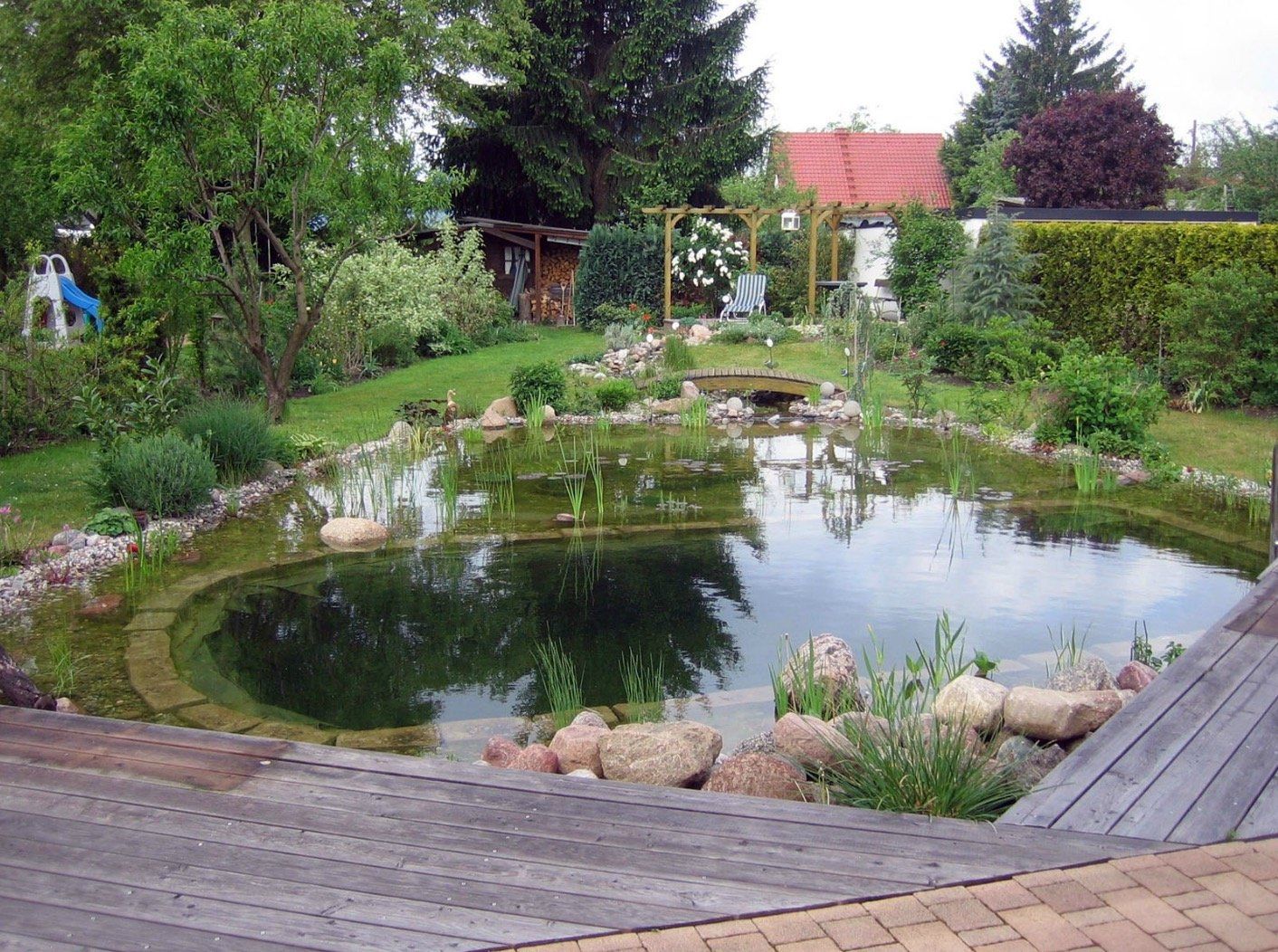 A large pond in the middle of a garden