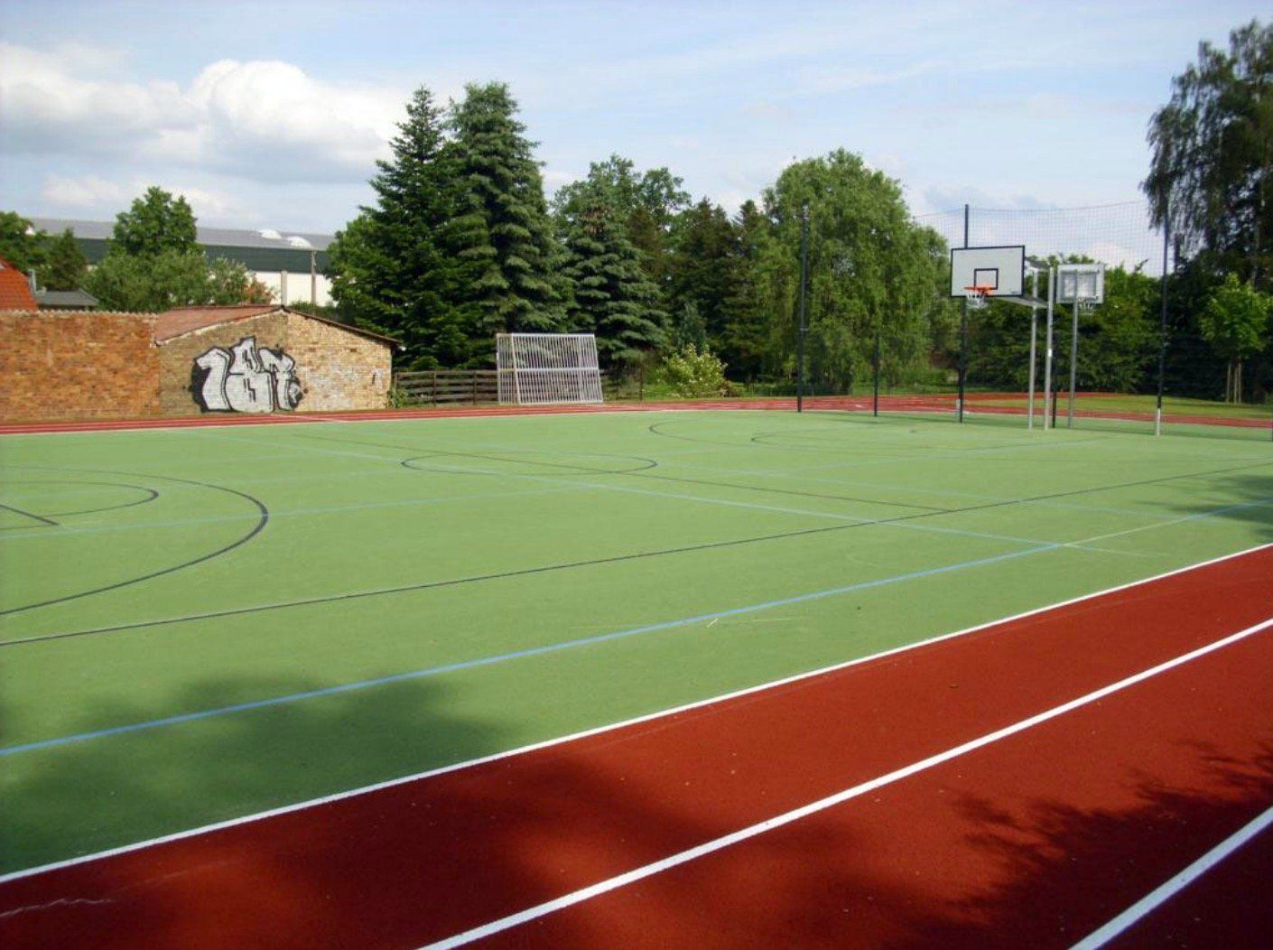 A basketball hoop is on the side of a basketball court