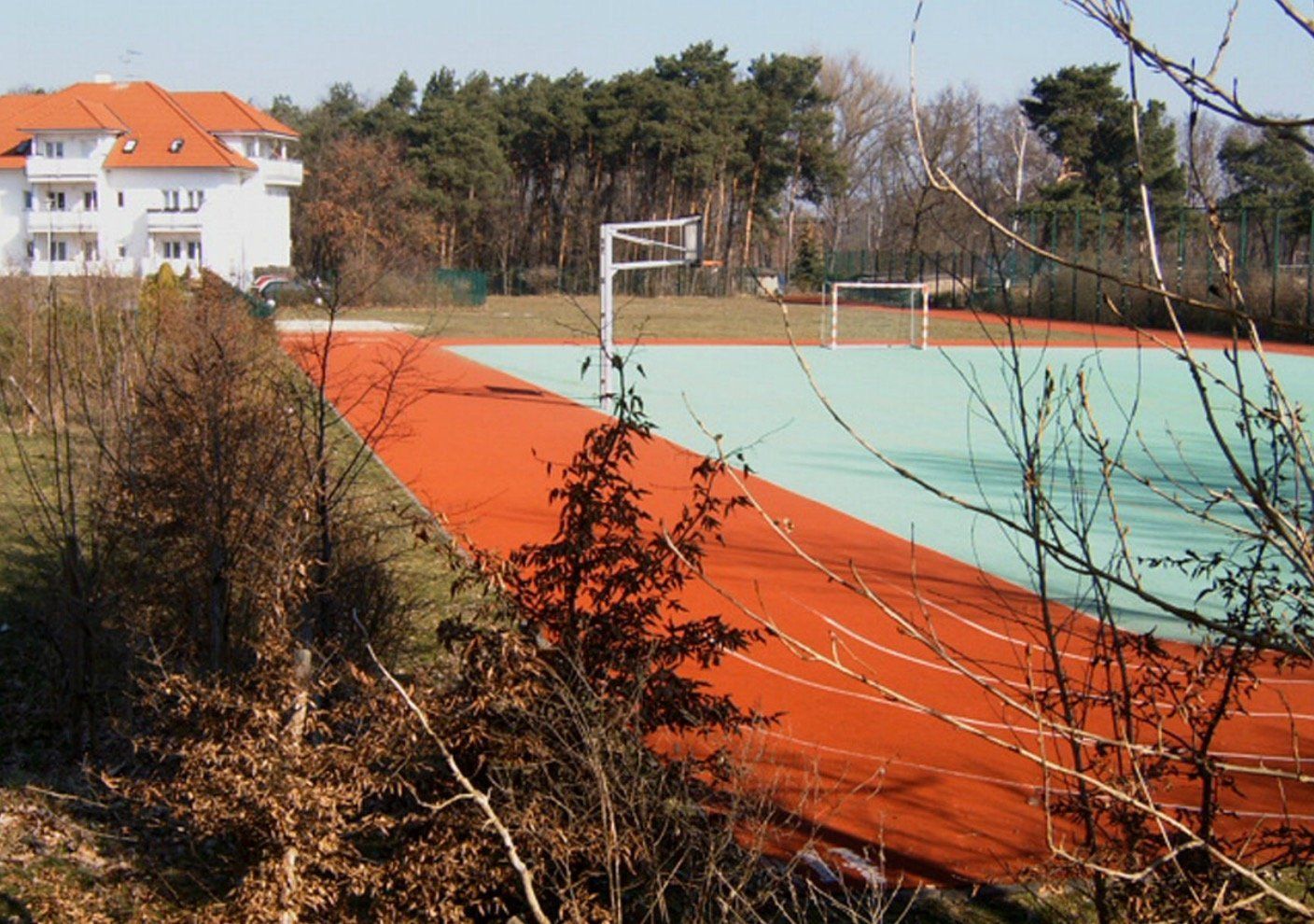 A basketball court with a building in the background