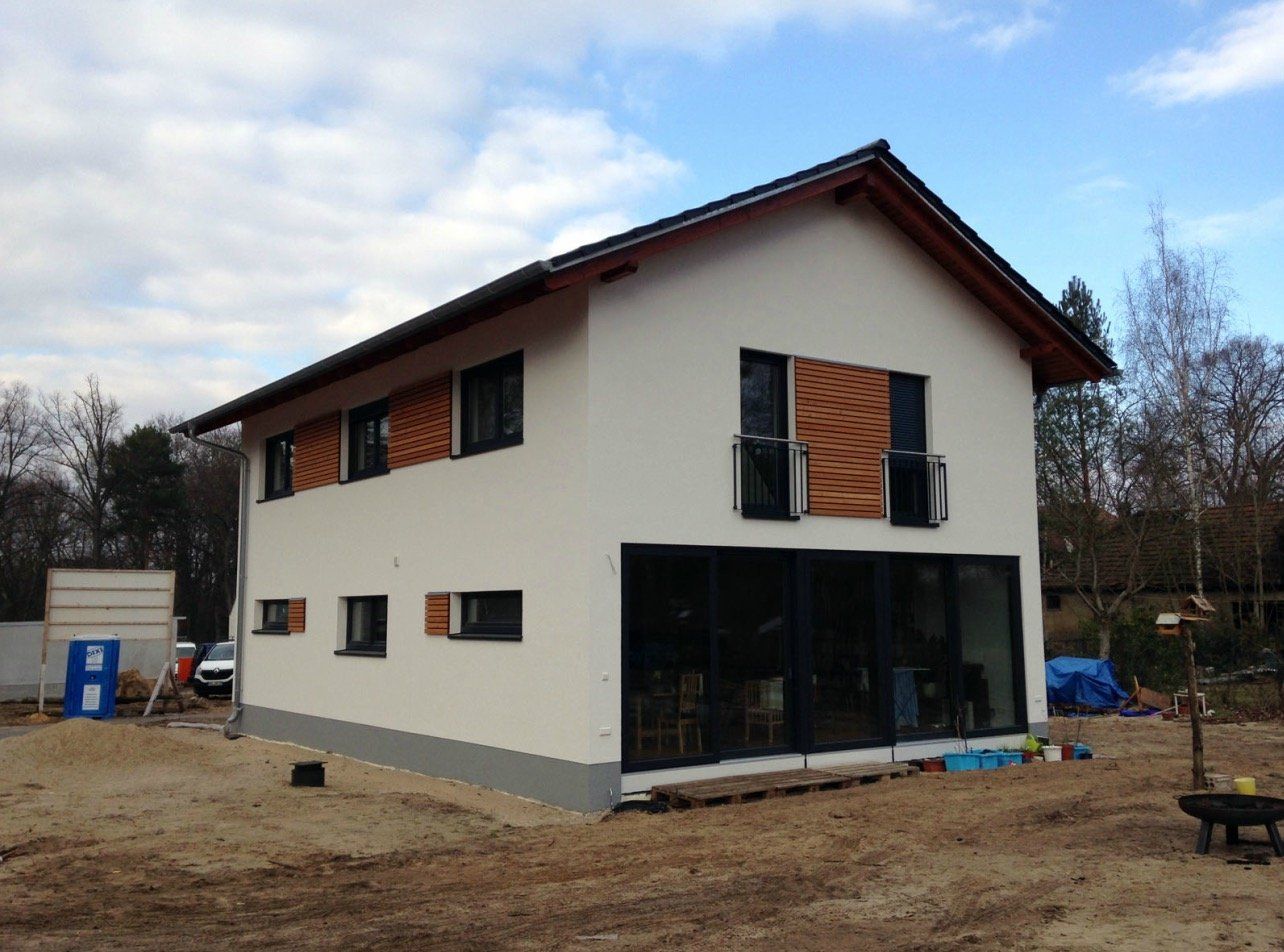 A white house with a lot of windows and shutters