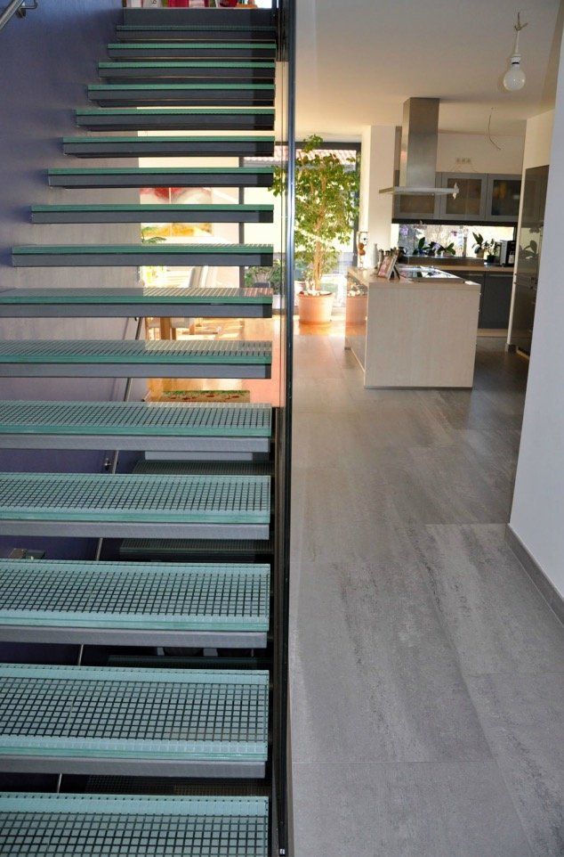 A staircase leading up to a kitchen in a house.