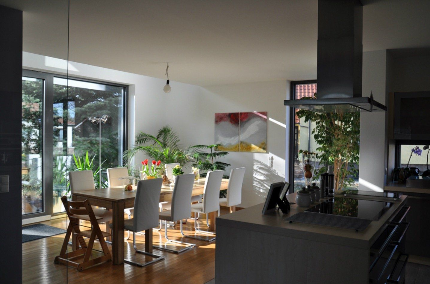 A kitchen and dining room in a house with a table and chairs