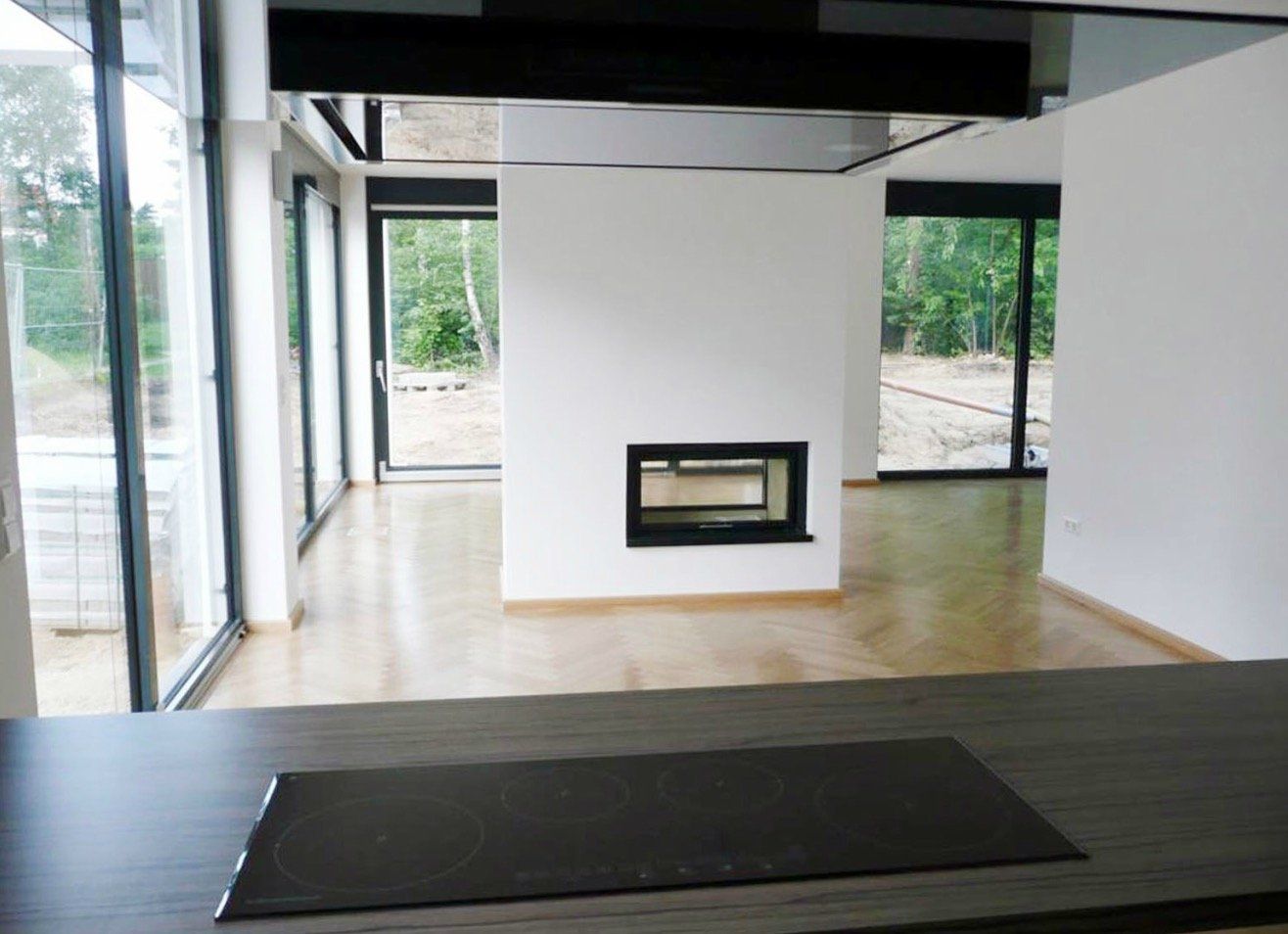 A kitchen with a stove top oven and a fireplace