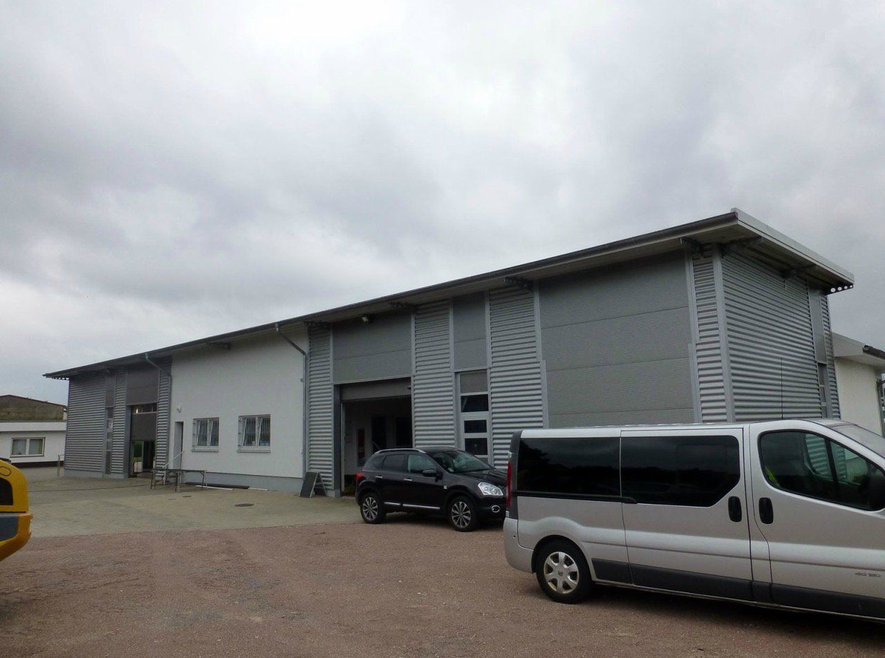 A van is parked in front of a large building