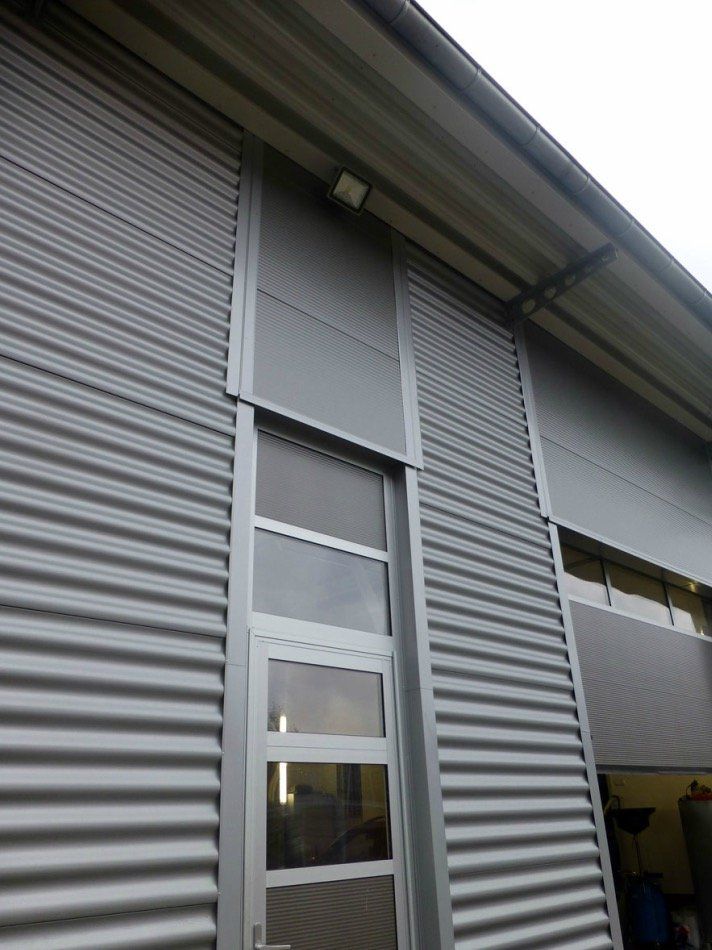 A gray building with a door and a window