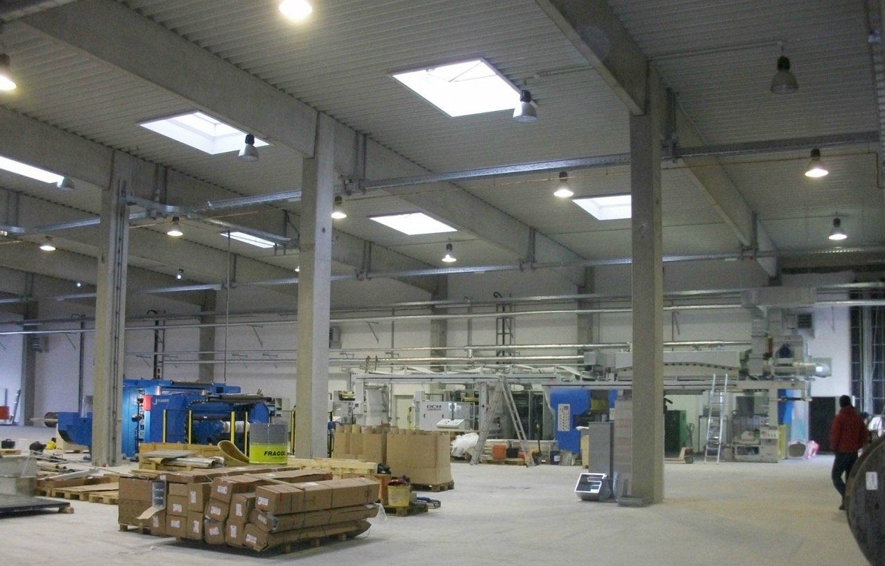 A large warehouse with a lot of boxes on the floor
