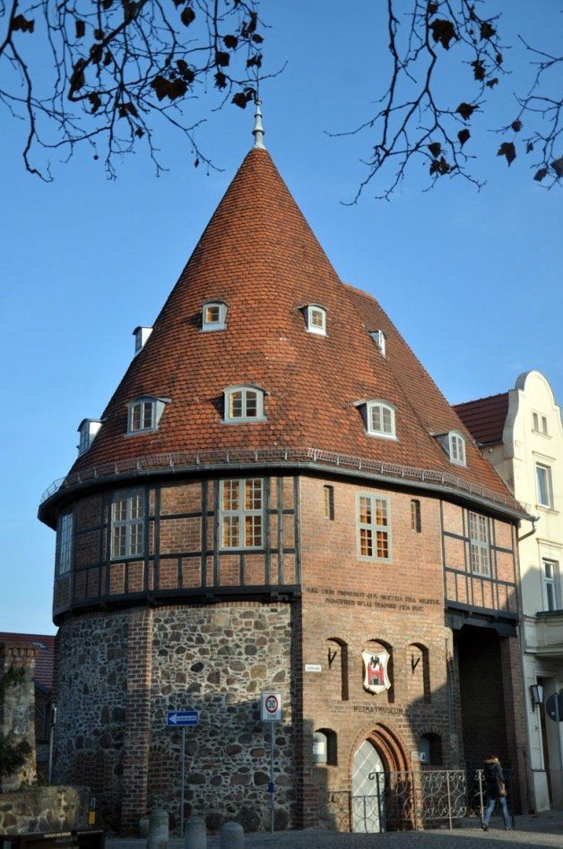 A brick building with a cone shaped roof