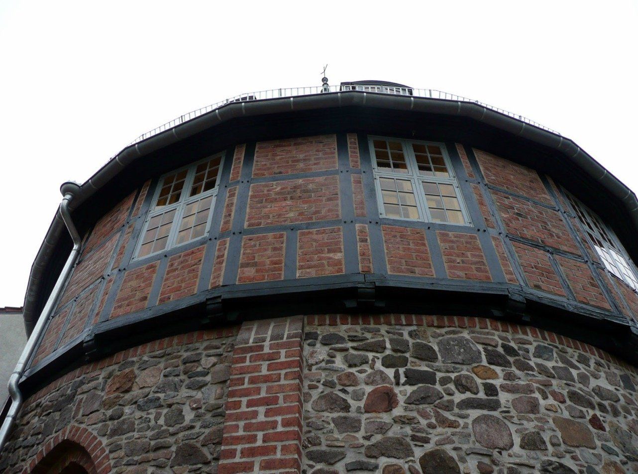 A brick building with a round roof and a lot of windows