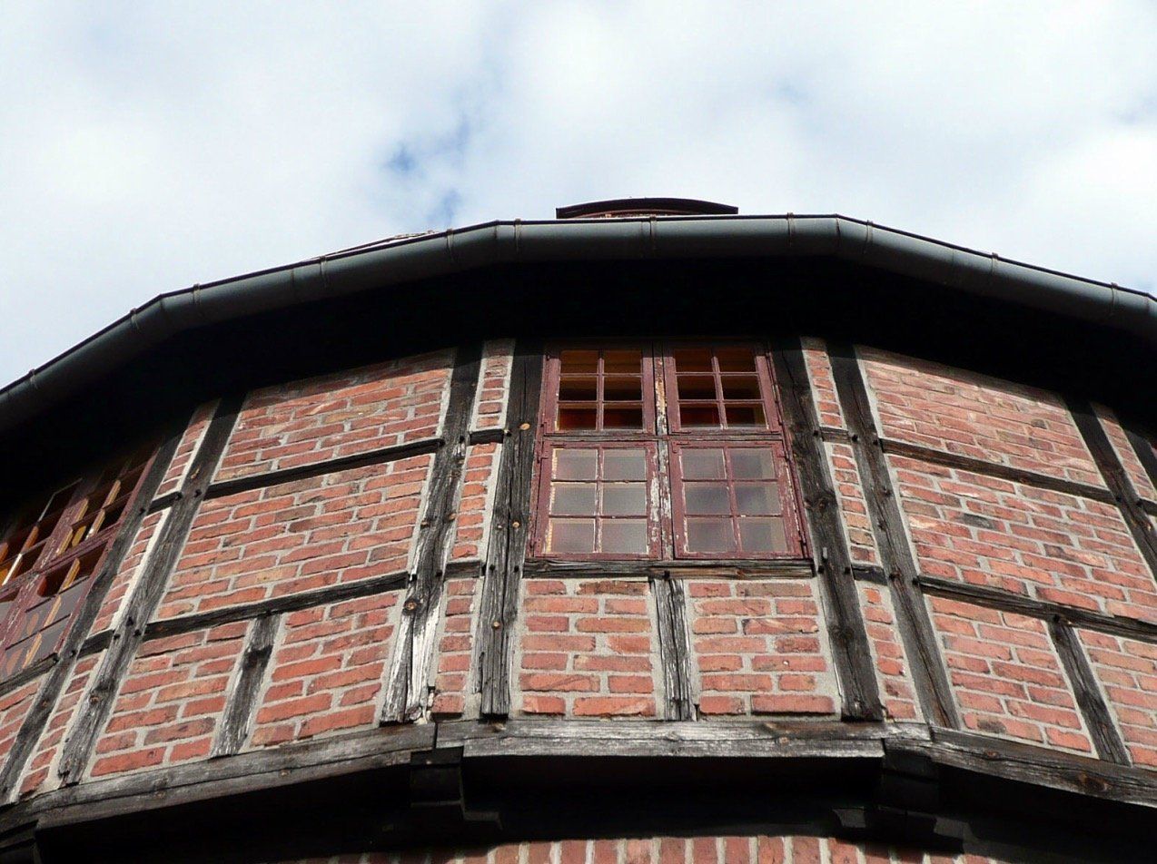Looking up at a brick building with a window