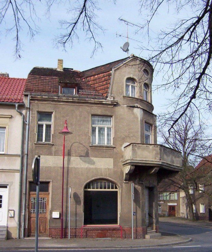 A building with a balcony on the top of it