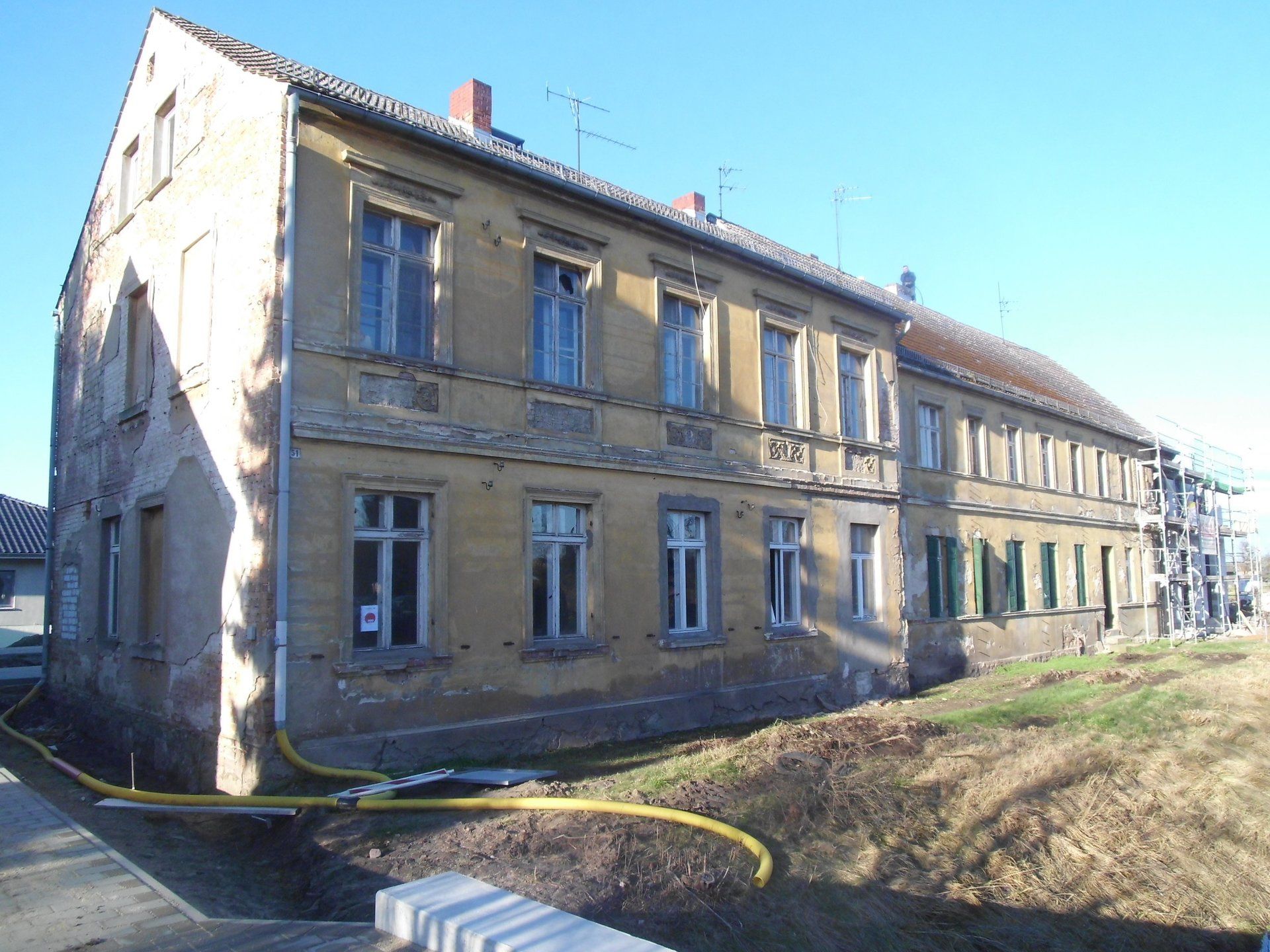 A large yellow building with a lot of windows