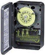 Open electrical timer switch with yellow dial and black cover hanging open