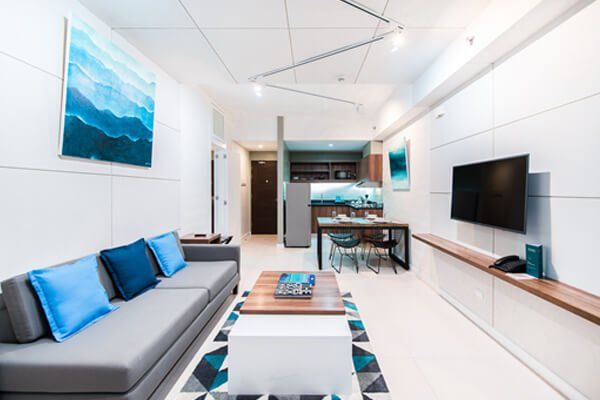 A living room with a couch , coffee table , and television.