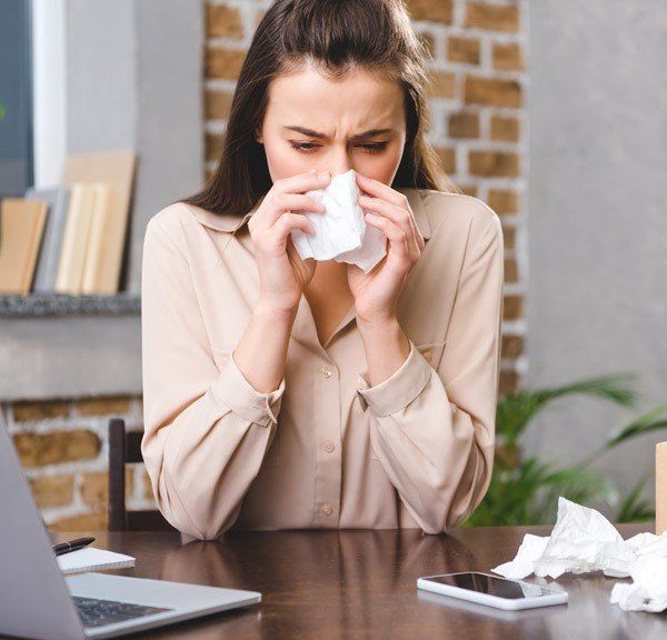 Woman Sneezing on Tissue — Manheim, PA — Garden Spot Mechanical, Inc. Woman Sneezing on Tissue — Manheim, PA — Garden Spot Mechanical, Inc.