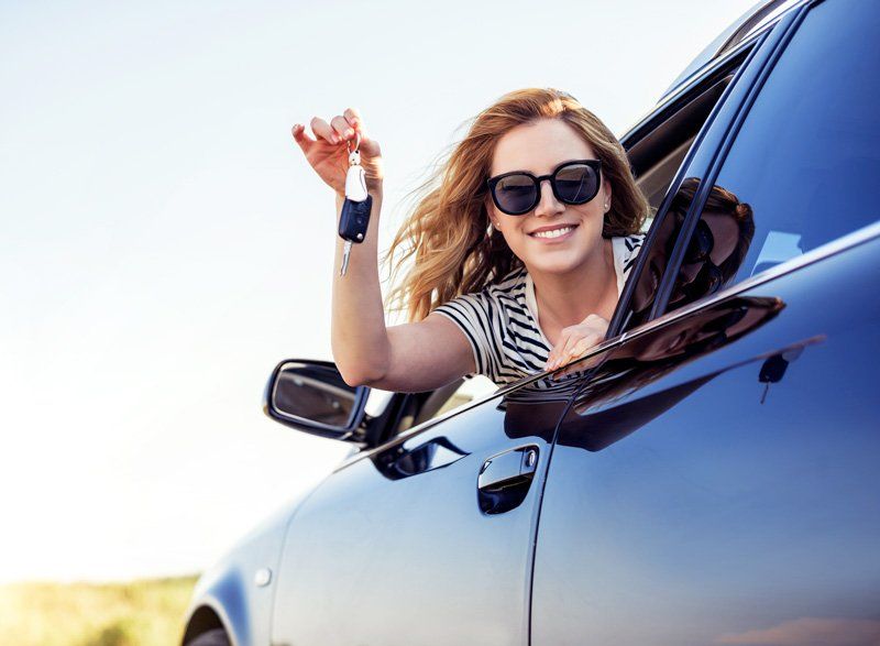 Woman Waving Her Car Keys — Ellendale, MN — Misgen Auto Parts Woman Waving Her Car Keys — Ellendale, MN — Misgen Auto Parts