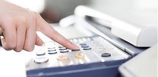 Woman Using Fax Machine — Fax orange in in Orange, NJ