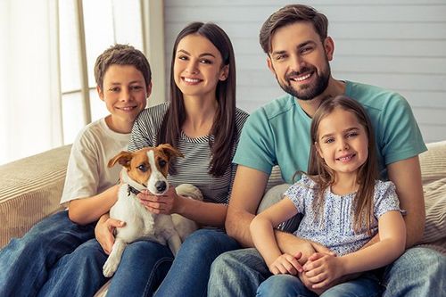 Family of four on couch.