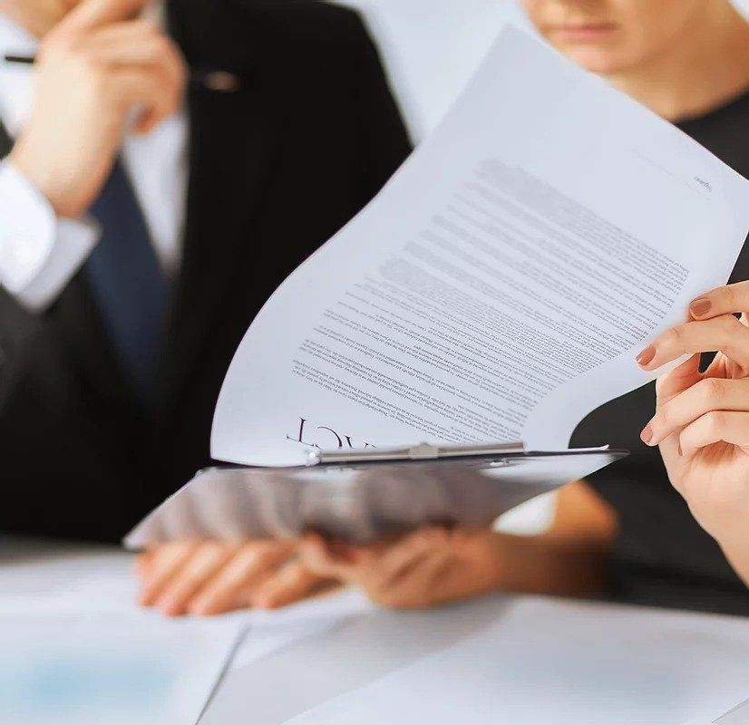 A woman is holding a clipboard with a piece of paper on it