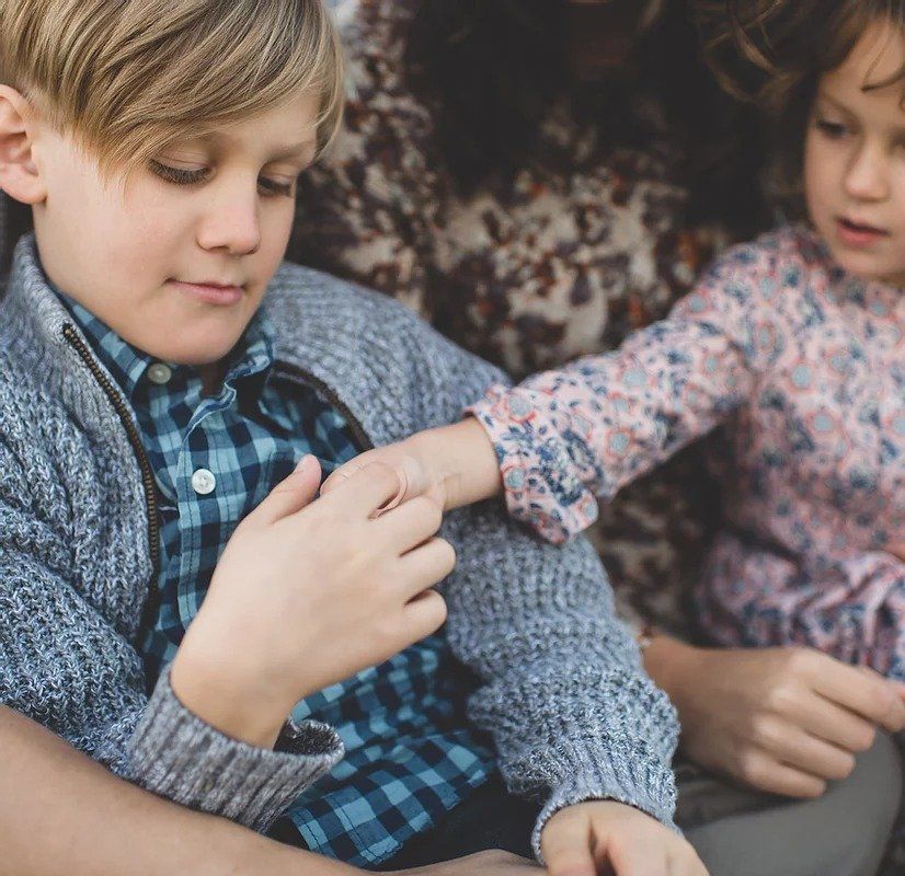 A boy and a girl are sitting next to each other