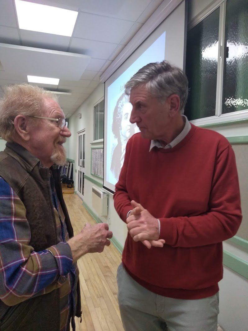 Mike Mann discusses dahlias with a club member