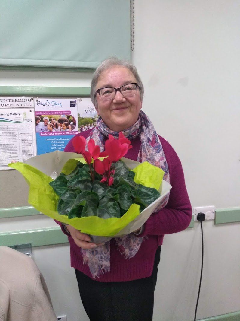 June Gurney receives a plant as thanks for serving on the Committee