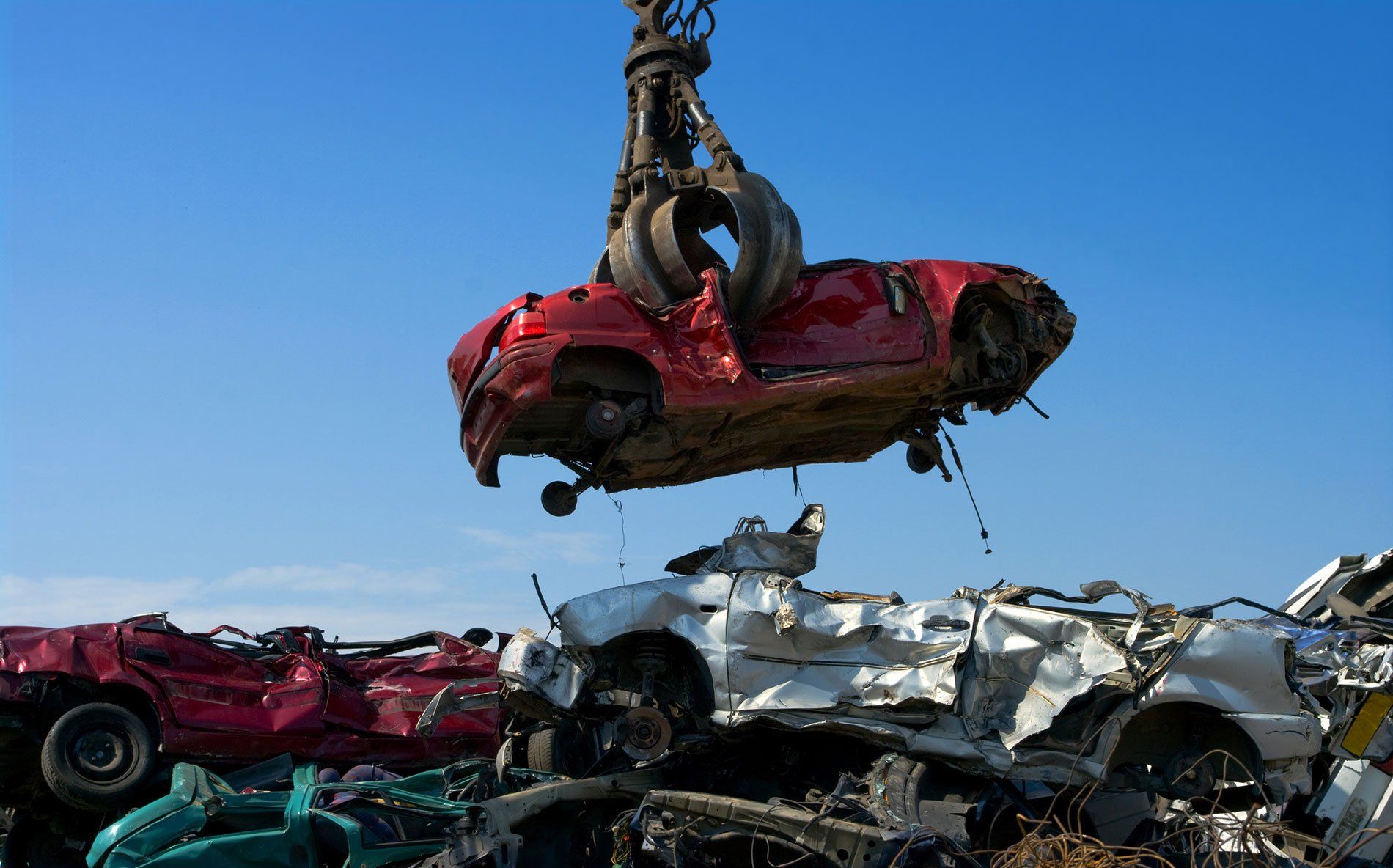 Crane picking up car
