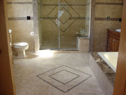 tile inlay on floor and shower walls of newly remodeled bathroom