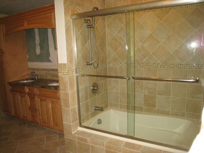 new shower, sink, and cabinets in remodeled bathroom