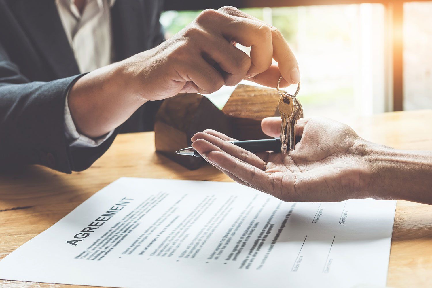 Real Estate Closing — Giving House Key with Contract Below in Richmond, VA