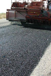 Double Chip Seal — Truck Dropping Asphalt On The Road in Denver, CO Double Chip Seal — Truck Dropping Asphalt On The Road in Denver, CO