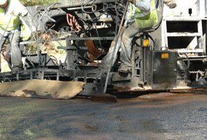 Asphalt Maintenance — Man On The Truck Smoothing The Road in Denver, CO Asphalt Maintenance — Man On The Truck Smoothing The Road in Denver, CO