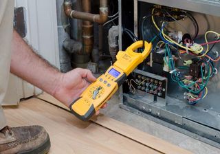 Man Checking Heater — HVAC in Spartanburg, SC